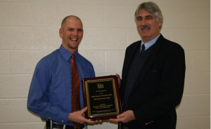 Photograph: Steve Toth (right) presenting plaque to Chris Mills (left) at Union County School Board Meeting in Monroe, North Carolina on March 3, 2009. Photograph by Rosemary Hallberg.