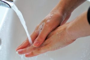 soapy hands under running water