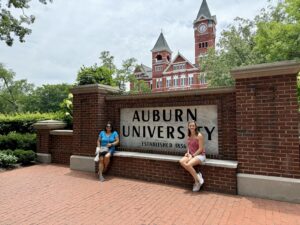 staff in front of Auburn University sign