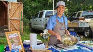 Margie Mansure, NC State Extension FCS agent in Watauga and Caldwell counties, offers up a tasty, healthy dish made with local ingredients at a farmers market.